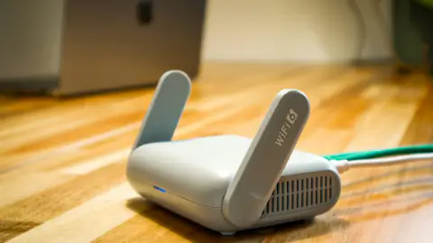 Wireless broadband router connected on a wooden desk